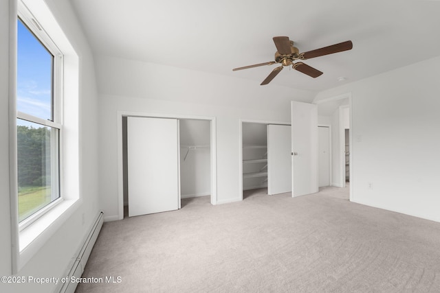 20337 State Route 171, Susquehanna, PA 18847 - unfurnished bedroom with light colored carpet, multiple closets, a baseboard heating unit, and a ceiling fan