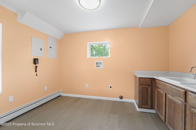 20337 State Route 171, Susquehanna, PA 18847 - washroom featuring a baseboard heating unit, electric panel, light wood finished floors, and hookup for a washing machine