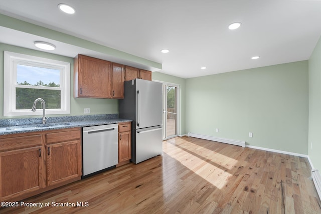 20337 State Route 171, Susquehanna, PA 18847 - kitchen with appliances with stainless steel finishes, a baseboard heating unit, brown cabinets, light wood-style flooring, and recessed lighting