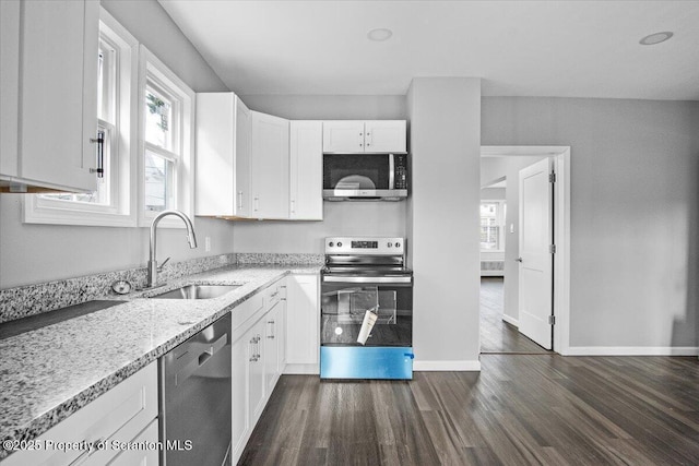 kitchen featuring stainless steel appliances, white cabinetry, and sink