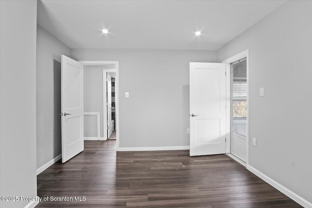 empty room with dark wood-type flooring