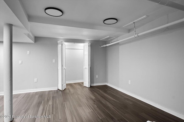 basement featuring dark hardwood / wood-style flooring