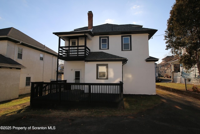 back of property with a balcony