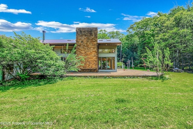 1742 State Route 848, New Milford, PA 18834 - back of property featuring a wooden deck, a yard, a chimney, and a metal roof