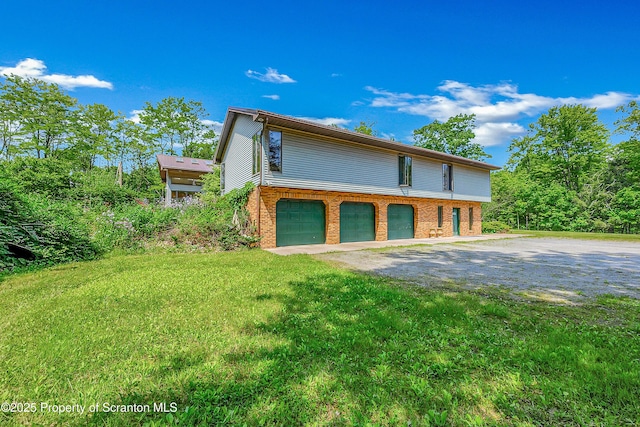 1742 State Route 848, New Milford, PA 18834 - view of front of house with brick siding, driveway, a garage, and a front yard