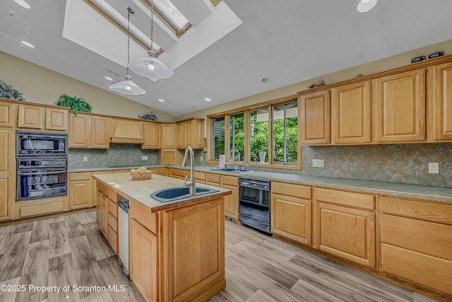 1742 State Route 848, New Milford, PA 18834 - kitchen with black appliances, a skylight, lofted ceiling, a kitchen island with sink, and tasteful backsplash