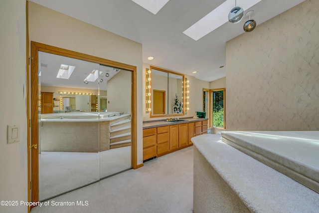 1742 State Route 848, New Milford, PA 18834 - bathroom with a skylight, a garden tub, vanity, and vaulted ceiling