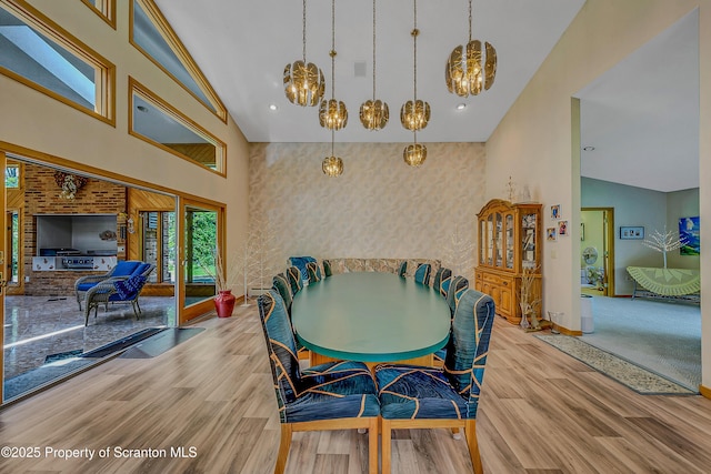 1742 State Route 848, New Milford, PA 18834 - dining area featuring a chandelier, high vaulted ceiling, and wood finished floors