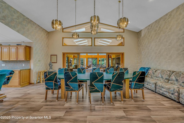 1742 State Route 848, New Milford, PA 18834 - dining area featuring a chandelier, high vaulted ceiling, and light wood finished floors
