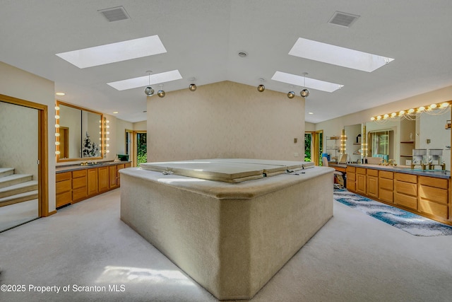 1742 State Route 848, New Milford, PA 18834 - bathroom featuring a skylight, a bath, two vanities, and lofted ceiling