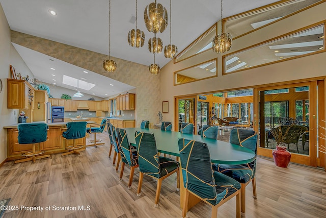 1742 State Route 848, New Milford, PA 18834 - dining area featuring recessed lighting, high vaulted ceiling, light wood-style flooring, and a skylight