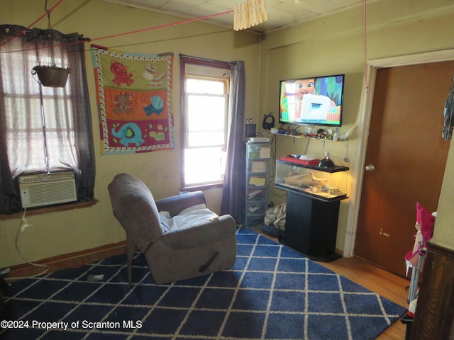 living area featuring cooling unit and wood-type flooring