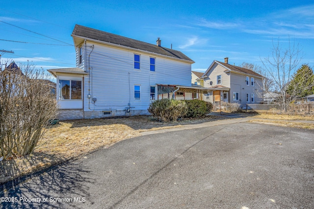 rear view of property with fence