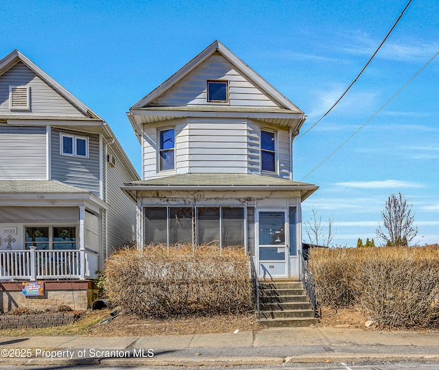 view of front of property featuring a sunroom and entry steps