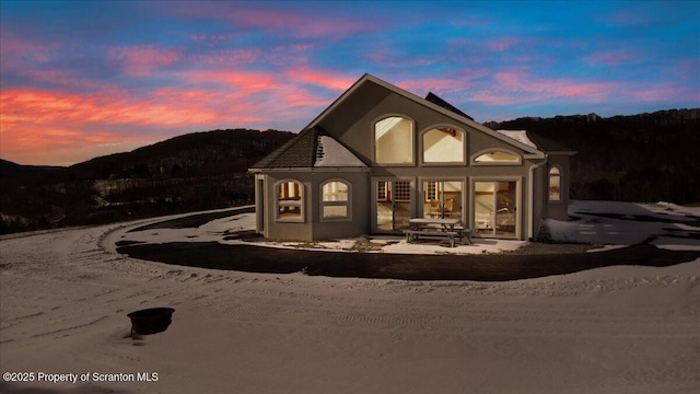 back house at dusk featuring a mountain view