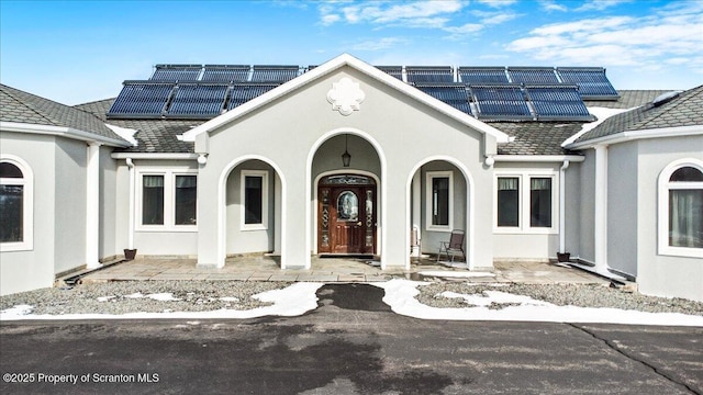 view of front of home featuring solar panels