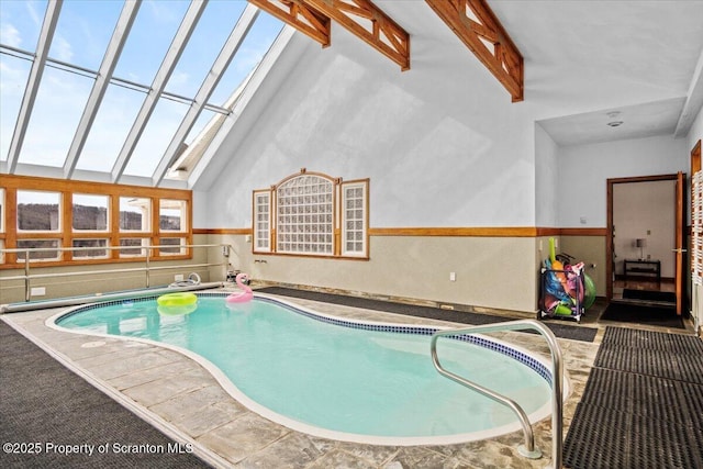 view of pool featuring a hot tub and a skylight