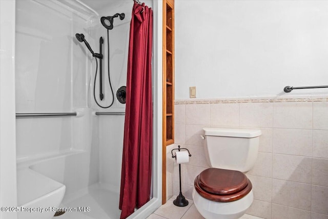 bathroom featuring tile walls, tile patterned flooring, curtained shower, and toilet