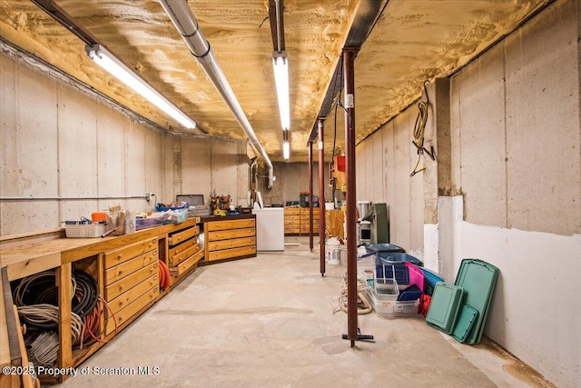 basement featuring washer / dryer and a workshop area