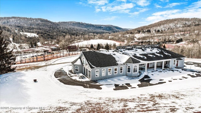 snowy aerial view with a mountain view