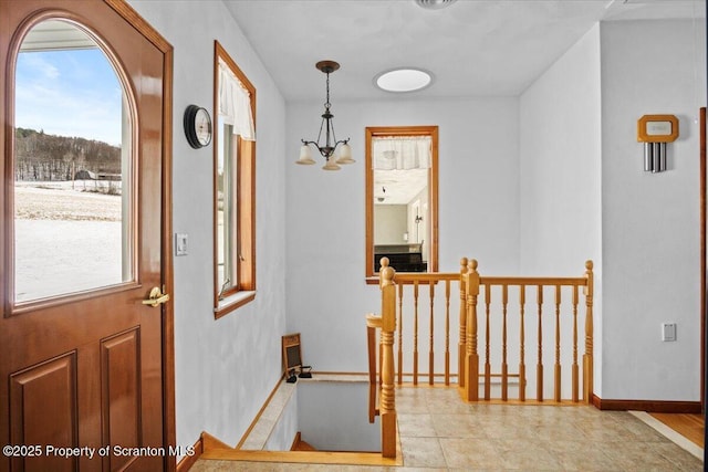 interior space featuring light tile patterned flooring and a notable chandelier