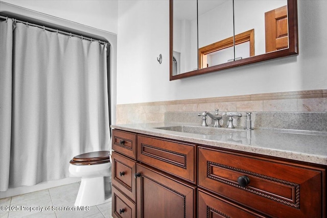 bathroom with vanity, toilet, and tile patterned flooring