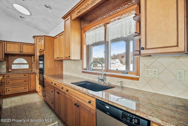 kitchen featuring vaulted ceiling, tasteful backsplash, sink, stainless steel dishwasher, and light stone counters