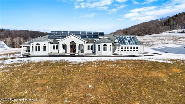 exterior space featuring a yard and solar panels