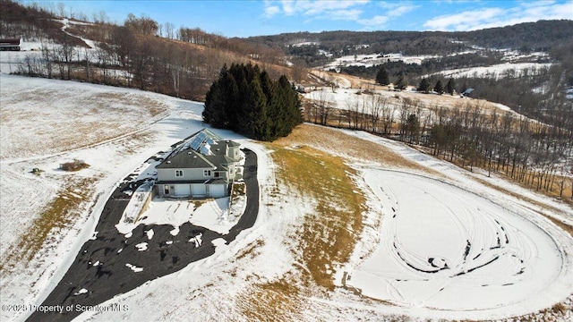 snowy aerial view featuring a mountain view