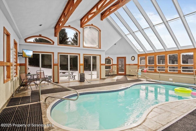 view of swimming pool with a jacuzzi and a skylight