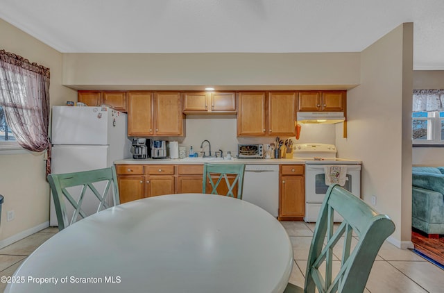 kitchen with sink, white appliances, and light tile patterned floors