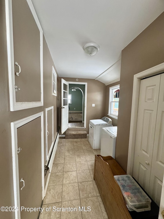 bathroom featuring tile patterned flooring, independent washer and dryer, and vaulted ceiling