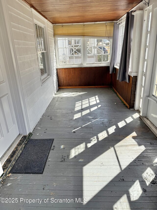 additional living space with hardwood / wood-style floors and lofted ceiling