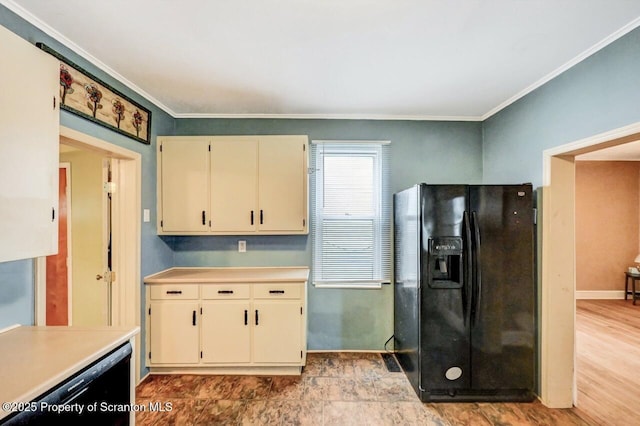 kitchen with cream cabinetry, crown molding, black appliances, and light countertops
