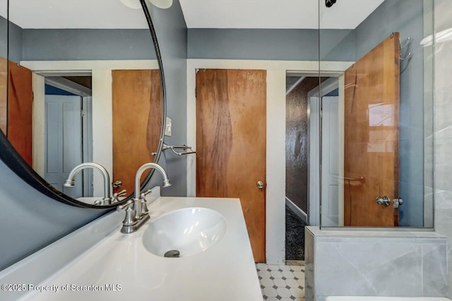 full bathroom with a shower with door and vanity