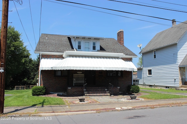 205 Orchard St, Old Forge, PA 18518 - view of front facade with brick siding, a chimney, covered porch, a shingled roof, and a front lawn