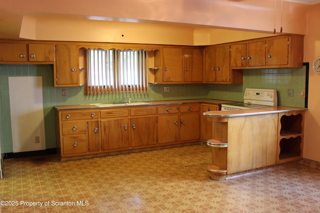 205 Orchard St, Old Forge, PA 18518 - kitchen featuring open shelves, brown cabinetry, range, and tasteful backsplash