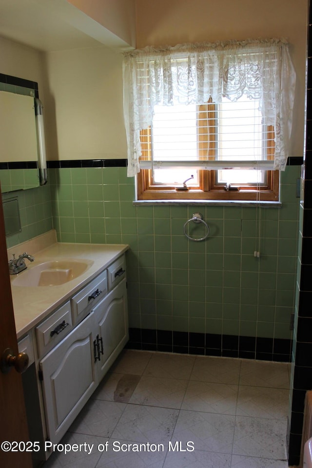 205 Orchard St, Old Forge, PA 18518 - bathroom featuring vanity, tile walls, wainscoting, and tile patterned flooring