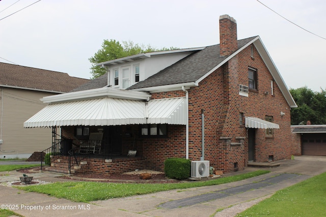 205 Orchard St, Old Forge, PA 18518 - view of front of home featuring a shingled roof, brick siding, a chimney, a garage, and a porch