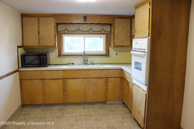 205 Orchard St, Old Forge, PA 18518 - kitchen with white oven, light countertops, and decorative backsplash