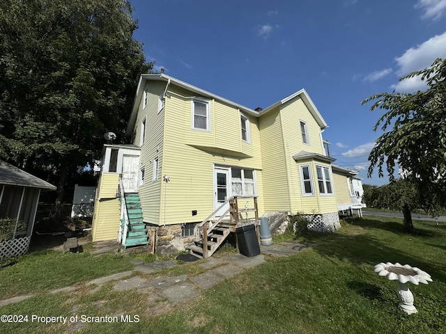 back of house with a yard