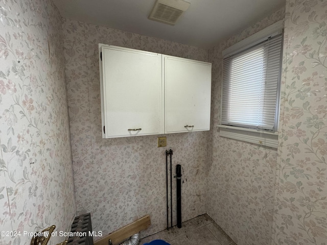 washroom with cabinets and light tile patterned floors