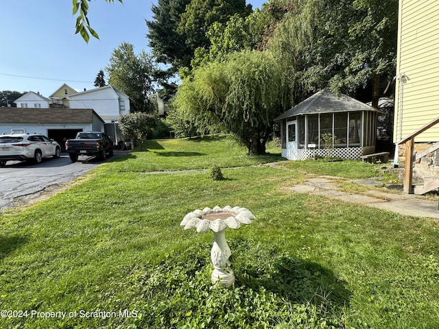 view of yard featuring a sunroom