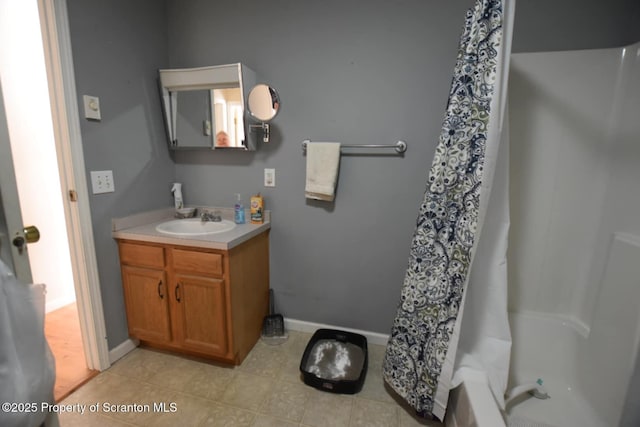 full bath with a shower with shower curtain, tile patterned floors, vanity, and baseboards