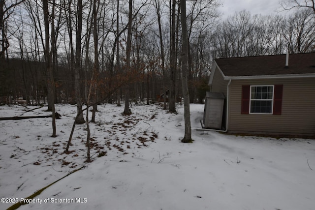 yard layered in snow featuring a garage