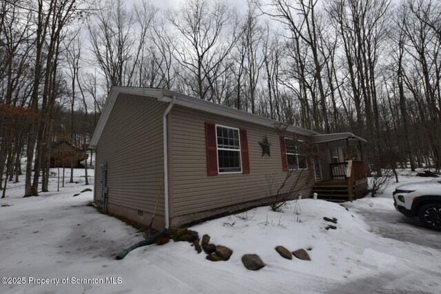 snow covered property with crawl space