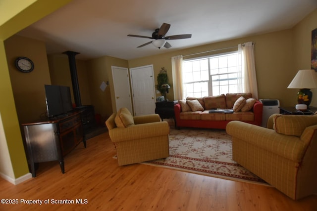 living area with light wood-type flooring and a ceiling fan