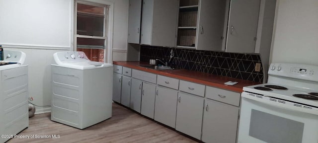 kitchen featuring electric stove, sink, white cabinetry, tasteful backsplash, and light hardwood / wood-style floors