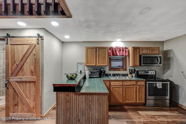 482 Lakeview Dr, Kingsley, PA 18826 - kitchen with appliances with stainless steel finishes, tile countertops, a sink, wood finished floors, and recessed lighting