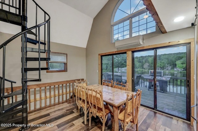 482 Lakeview Dr, Kingsley, PA 18826 - dining room with a wall mounted air conditioner, wood finished floors, high vaulted ceiling, plenty of natural light, and stairway